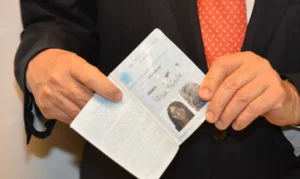 Pessoa segurando o passaporte, documento necessário para solicitação de seguro-desemprego em 2025.