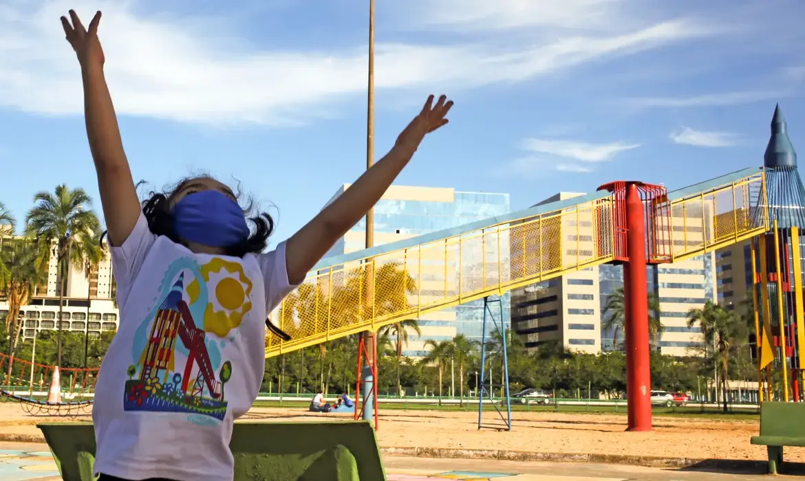 Imagem de uma criança brincando em um parque, simbolizando a importância de um laudo para comprovar a deficiência e acessar o auxílio.
