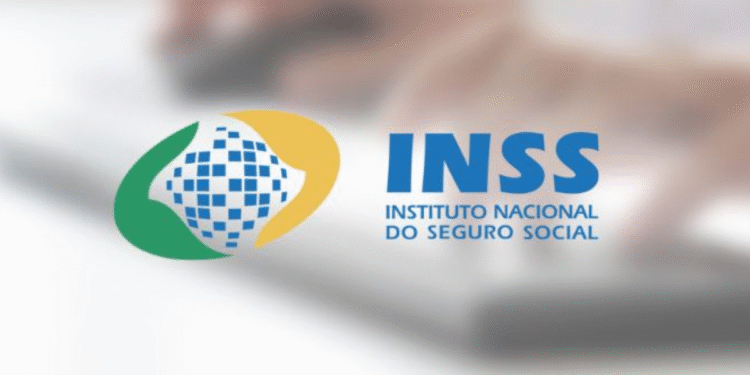 Logo do INSS com fundo borrado de uma mão sobre um teclado, destacando o tema de pagamentos de junho."