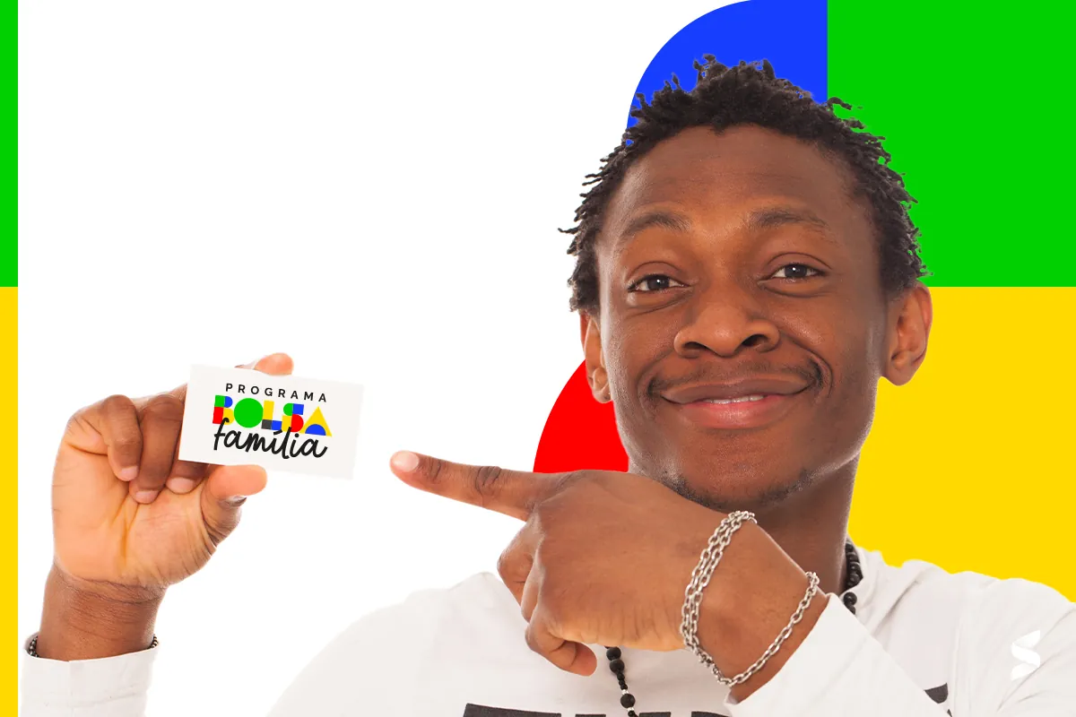 Homem sorridente segurando um cartão do Programa Bolsa Família com fundo colorido.