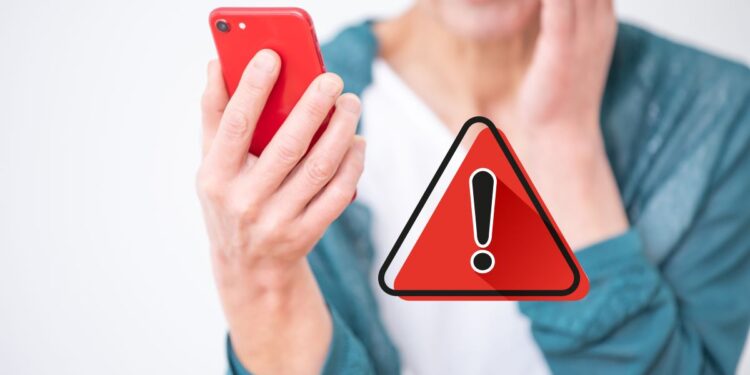 Pessoa chocada olhando o celular, com um ícone de alerta vermelho, representando golpes e perigos online.