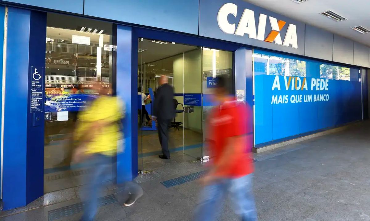 Agência da Caixa Econômica Federal com pessoas entrando para atendimento bancário