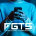 Trabalhador consulta informações sobre o saque do FGTS pelo celular, com o logo do Fundo de Garantia em destaque