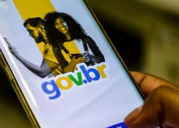 Mão segura um celular com a tela do aplicativo Gov.br