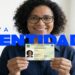 Mulher sorridente com óculos segura nova carteira de identidade brasileira, texto "Nova Identidade" em azul