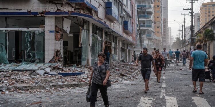Imagem ilustrativa de rua com prédios danificados e escombros após o terremoto de 7,5 na Venezuela, onde dezenas de edifícios desabaram.