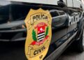 Brasão da Polícia Civil de São Paulo na lateral de uma viatura preta, durante a operação contra a lavagem de dinheiro do PCC.