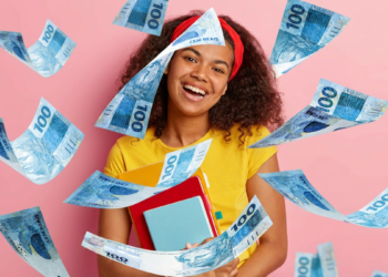 Jovem sorridente com livros cercada por notas de 100 reais em fundo rosa.