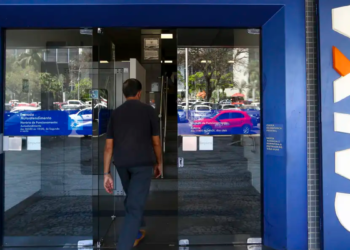 Cliente acessa agência da Caixa Econômica Federal em área urbana.