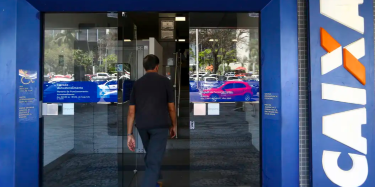 Cliente acessa agência da Caixa Econômica Federal em área urbana.