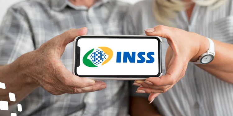 Duas pessoas seguram celular exibindo logo do INSS, foco nas mãos e aparelho.